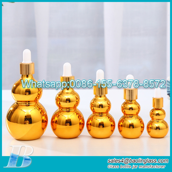 Botella de aceite esencial de vidrio chapado en oro eléctrico UV con forma de calabaza