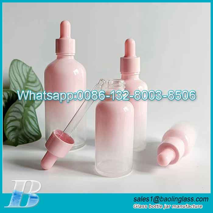 Botella de aceite esencial de vidrio de color rosa con cuentagotas