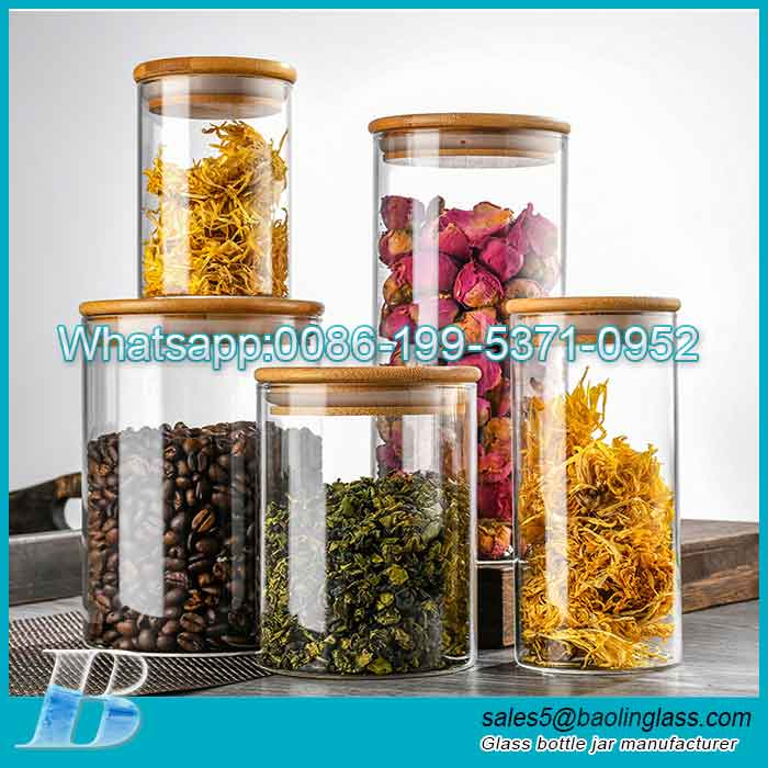 Tarro de almacenamiento de vidrio de borosilicato alto transparente redondo al por mayor con tapa de madera para almacenar té/especias